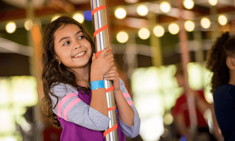 Girl riding a carousel