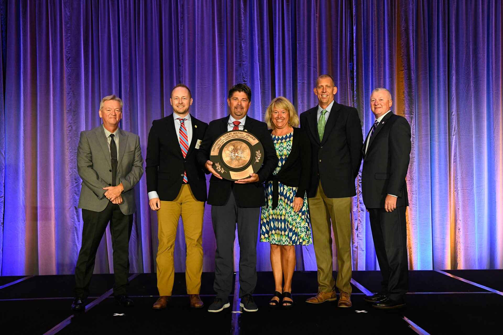 Group of people posing with an award