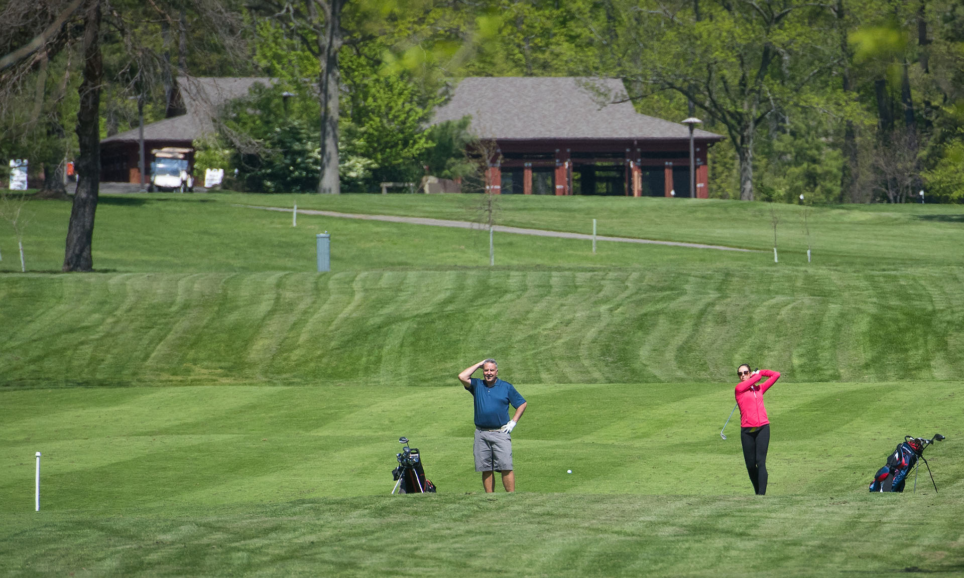 People golfing on a golf course