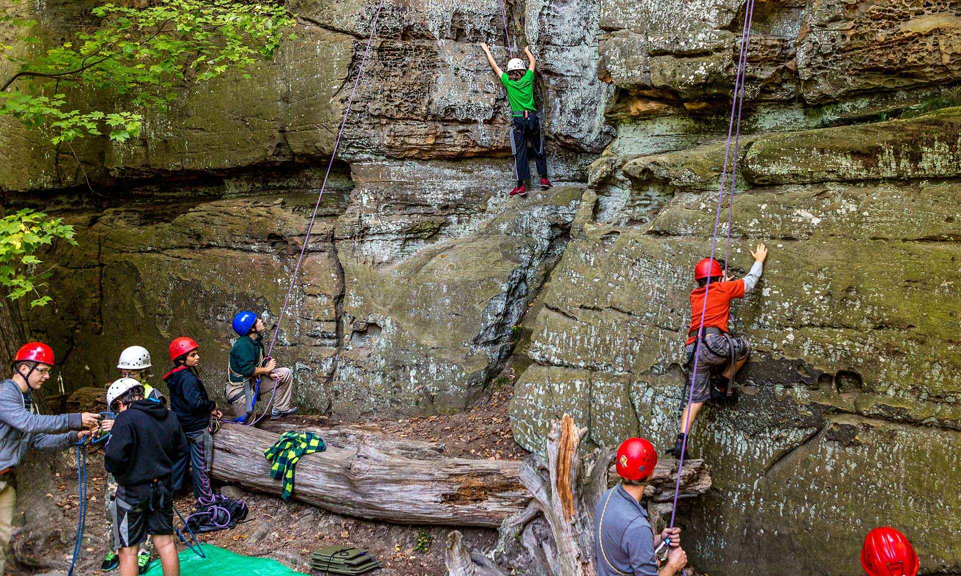 people rock climbing