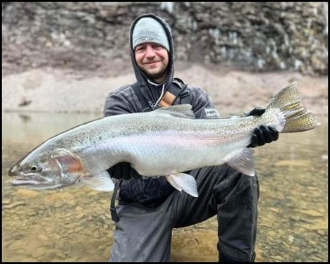 Man smiling and holding a fish