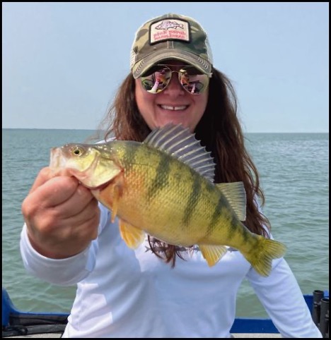 Woman smiling and holding a fish