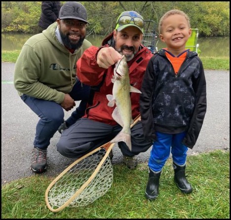 Group of people holding a fish