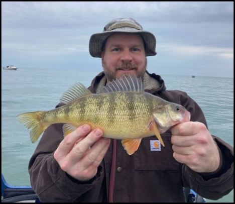 Man smiling and holding a fish