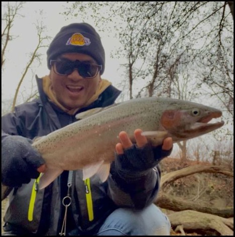 Man smiling and holding a fish