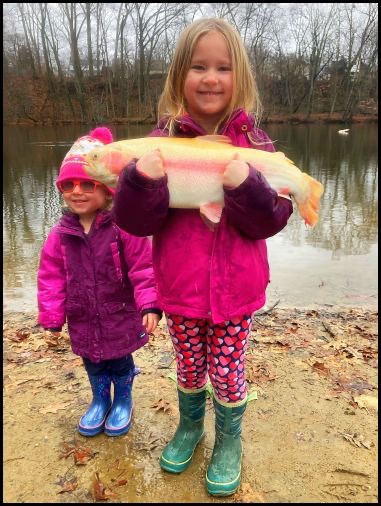 Two children holding a fish