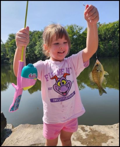 Girl holding a fish on a hook