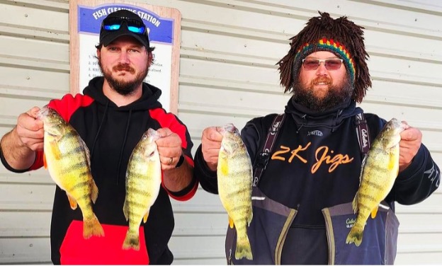 Two men holding fish