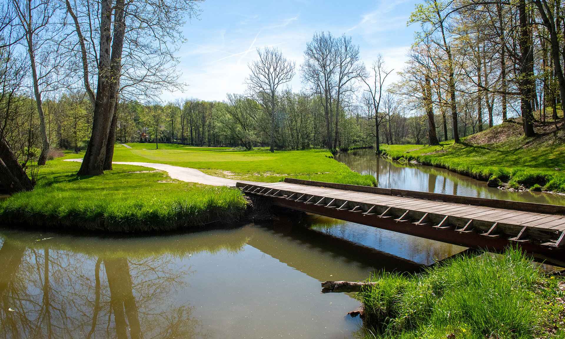 A pond and bridge on a golf course