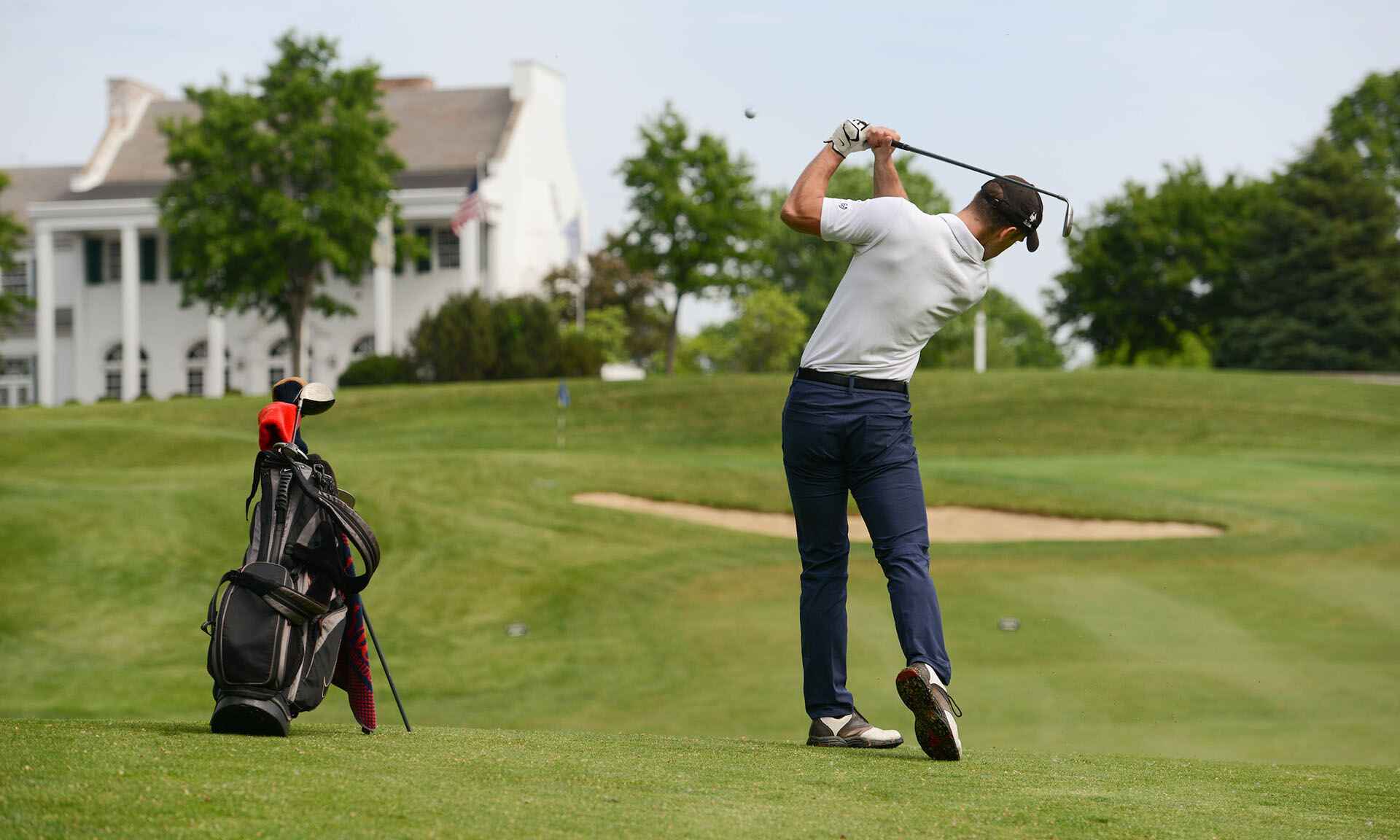 A man swinging a golf club on a golf course