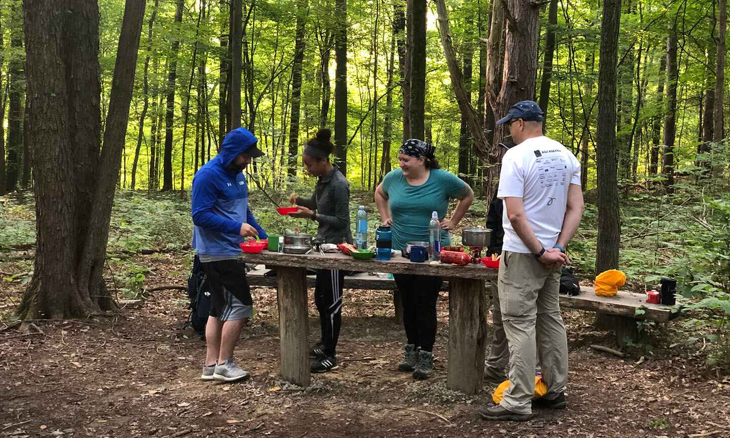 People cooking at a campsite