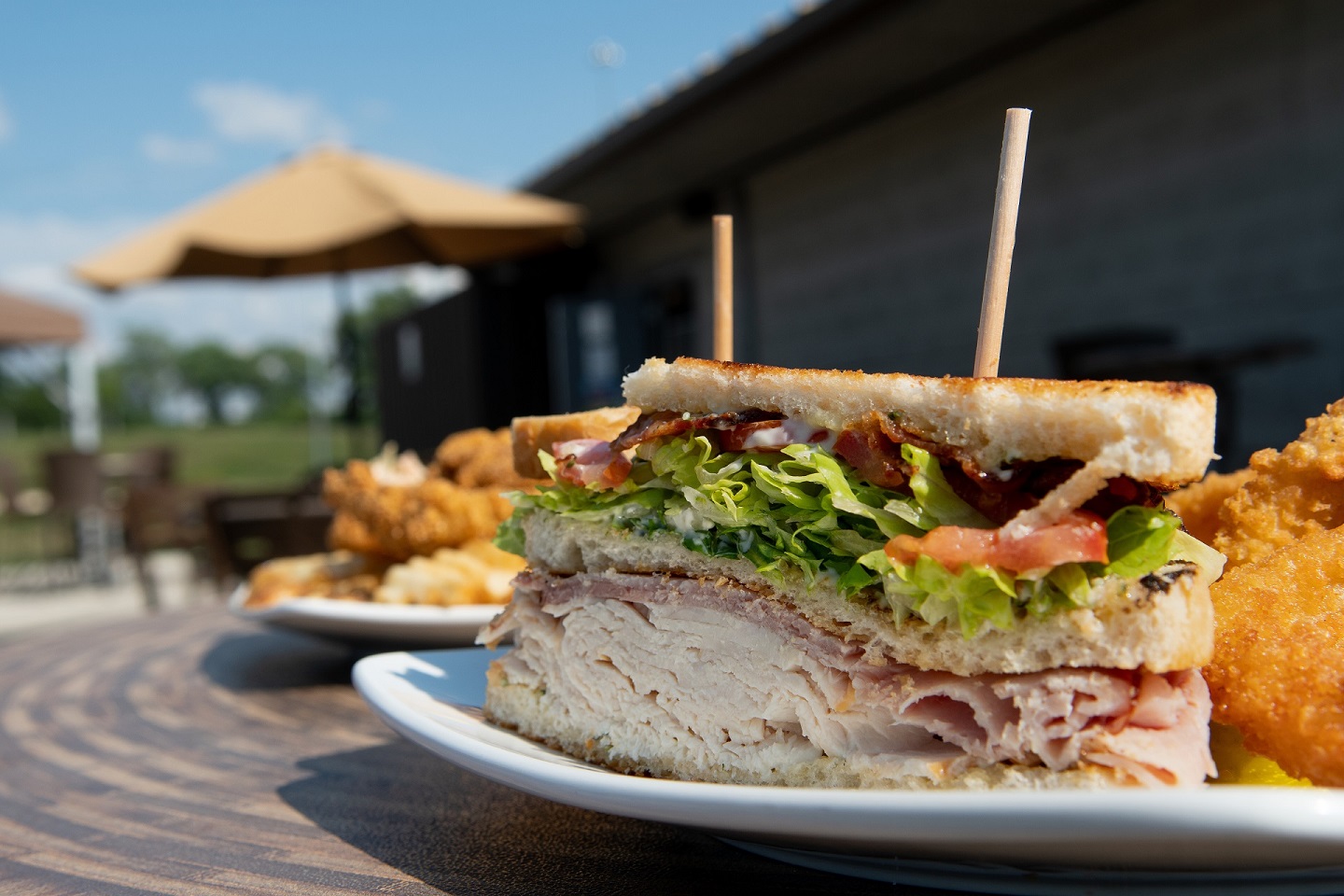 Turkey and bacon sandwich on an outdoor table